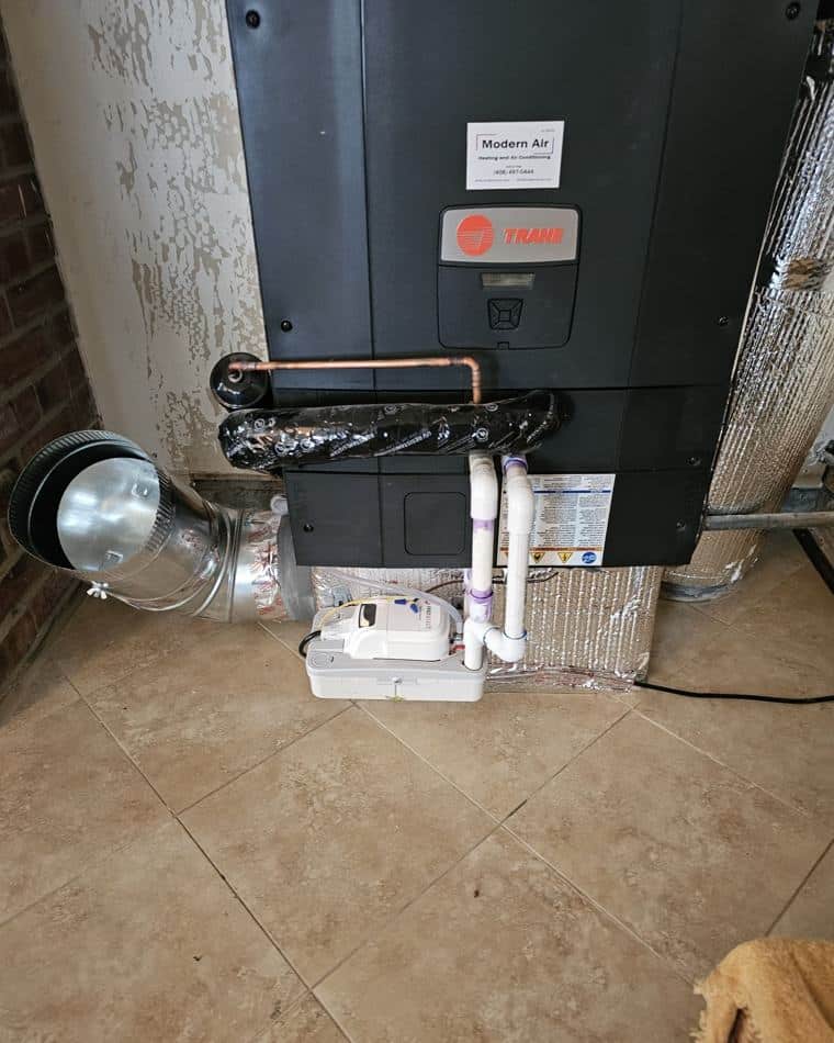 Furnace and venting installed by Modern Air, service sticker on the cabinet