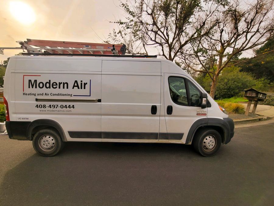 Modern Air service van with full company livery, ladders racked and ready