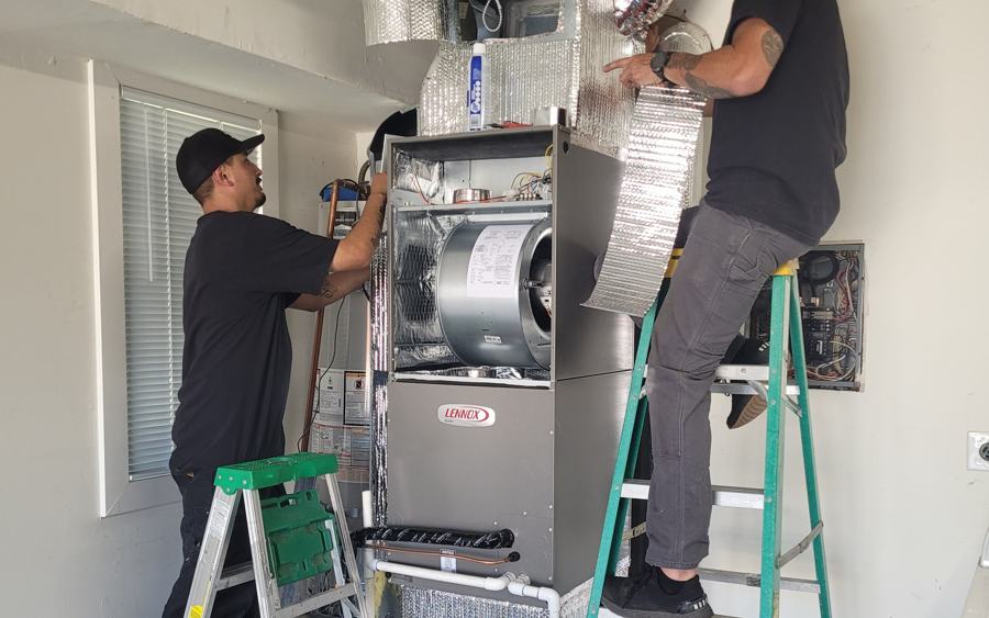 Modern Air technicians installing an air handler with new sealed ductwork